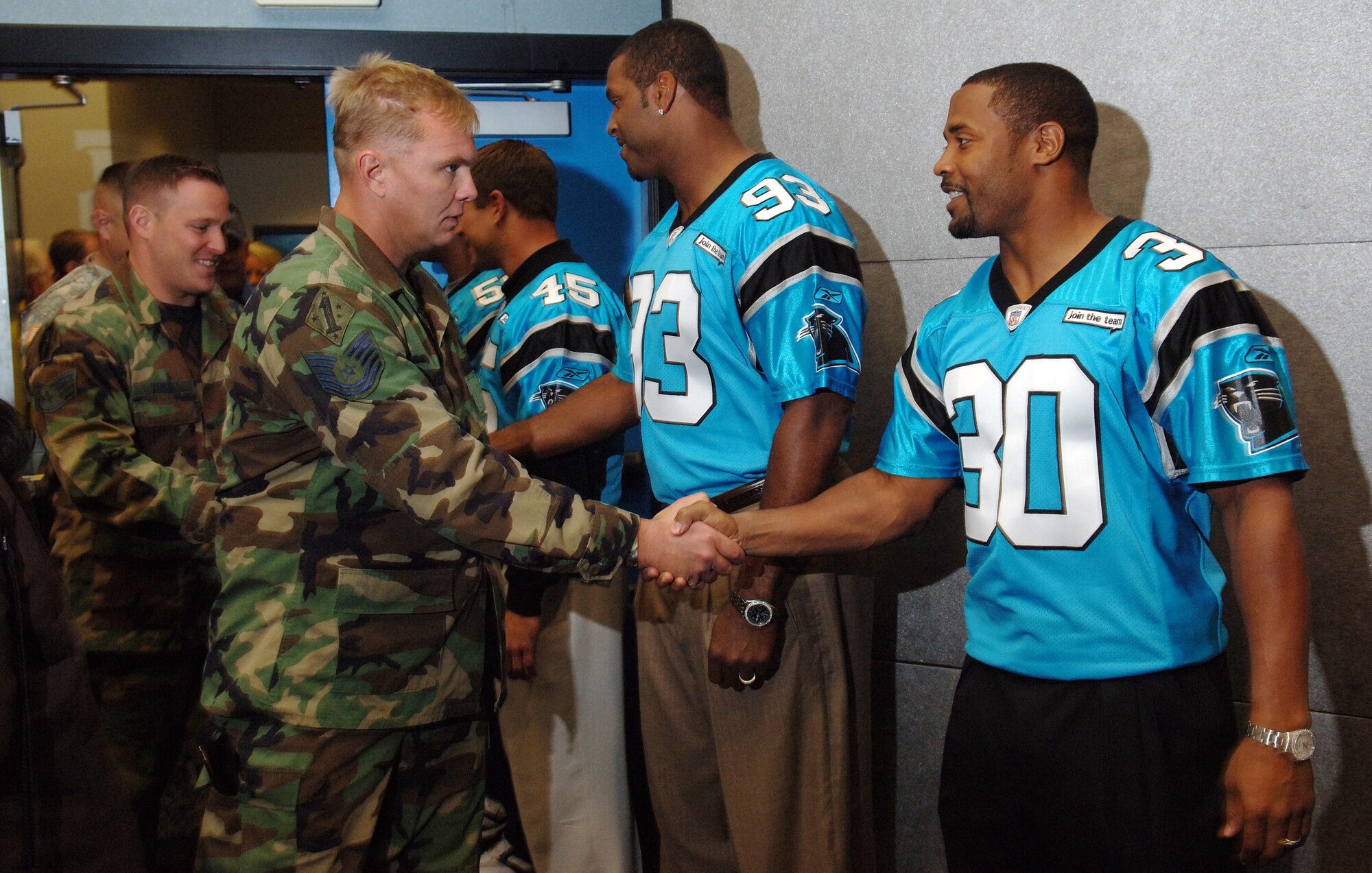 Tech. Sgt. Greg Overbay meets Carolina Panthers safety Mike Minter as part of Operation Welcome Home, inside the Bank of America Stadium, Charlotte N.C., on Oct. 24. Home allowed military members from the Air Force, Army, Navy and Marines to tour the stadium and meet several players from the Carolina Panthers as a thank you after deploying in support of Operations Iraqi Freedom and Enduring Freedom. Sergeant Overbay is in the Air National Guard and is a tactical air controller with the 118th Air Support Operations Squadron, New London, N.C. (U.S. Air Force photo/Tech. Sgt. Larry A. Simmons)
