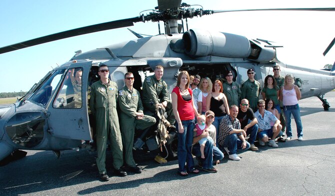 Airmen from the Air Force Reserve Command's 920th Rescue Wing flew a rescue mission Oct. 1 and saved five men tossed into the Atlantic Ocean after a boating incident.  Each of the five rescued men, their families and the Reserve crew that was part of their joint rescue team pose for a photo in front of the aircraft that extracted the final survivor from the cold Atlantic waters three weeks earlier. (U.S. Air Force photo/Senior Airman Jonathan Simmons)