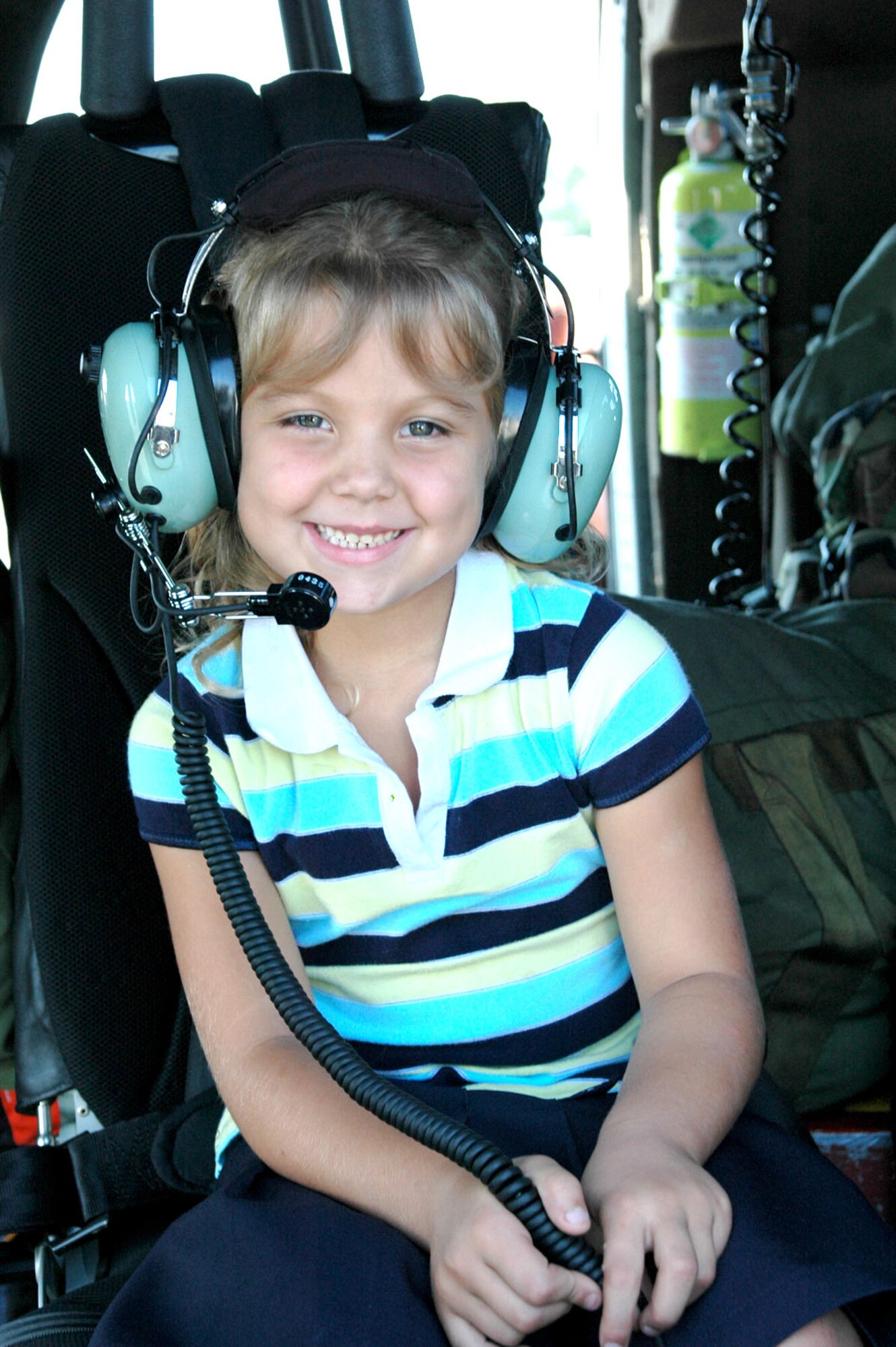 Three weeks after her father, Clinton, was rescued from the chilly waters of the Atlantic Ocean by pararescuemen from the Air Force Reserve Command's 920th Rescue Wing, five-year-old Tristan Doughtry tries out the communications equipment on the "Jolly" that rescued her daddy Oct. 1. (U.S. Air Force photo/Senior Airman Jonathan Simmons) 