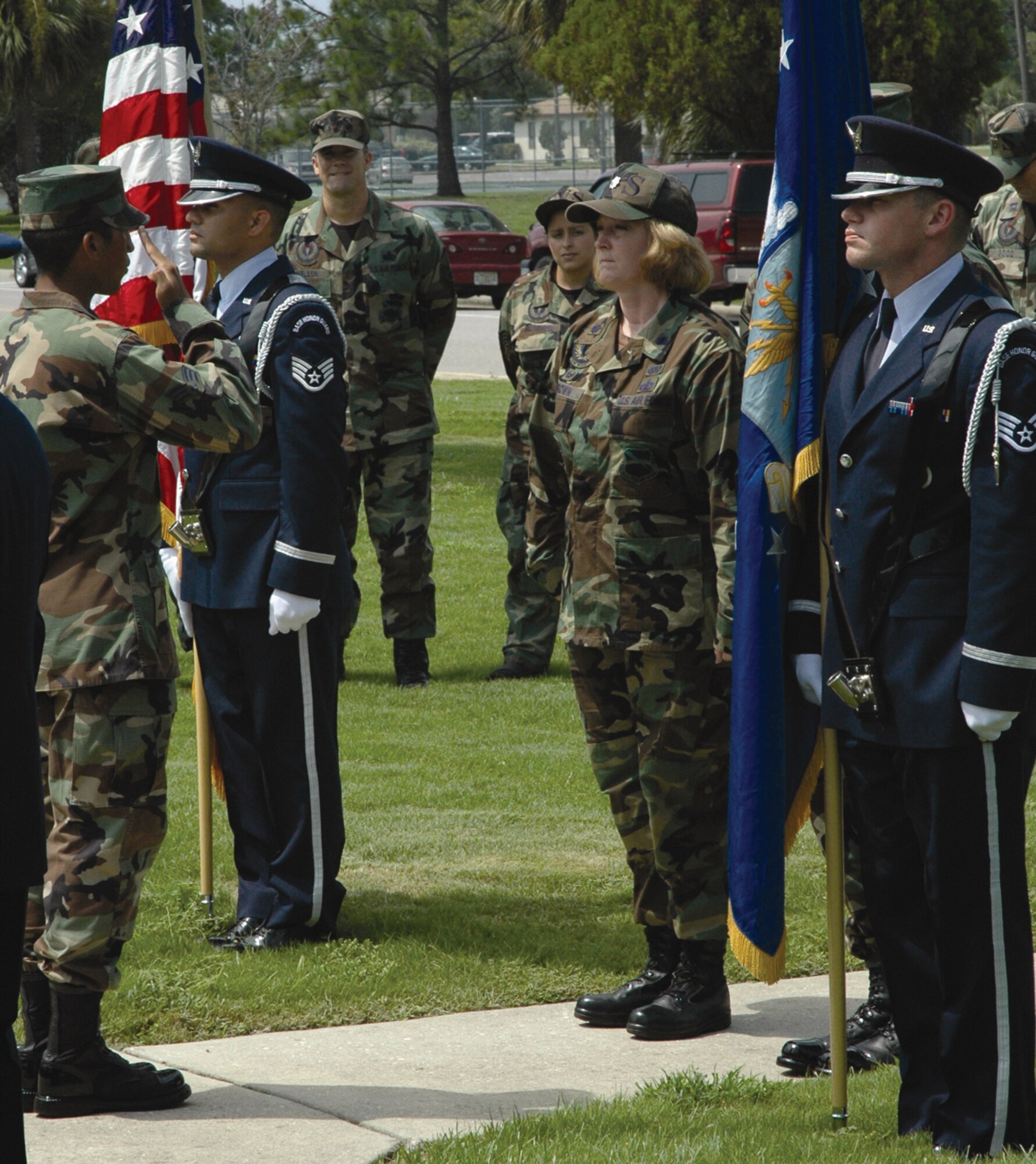 TYNDALL AFB, Fla. --  Tyndall Honor Guard members, Staff Sgts. Joseph Alers and Austin Weeks (far right), stand at attention during a graduation ceremony for 14 newly inducted Honor Guard members Aug. 18 here. Senior Airman Aquilino Alveo-Forbes (far left), Honor Guard lead trainer, presented the flight of graduates to Lt. Col. Cynthia Brown, 325th Services Squadron commander, as first sergeants, supervisors and other supporters looked on. (U.S. Air Force photo by 1st Lt. Amanda Ferrell)