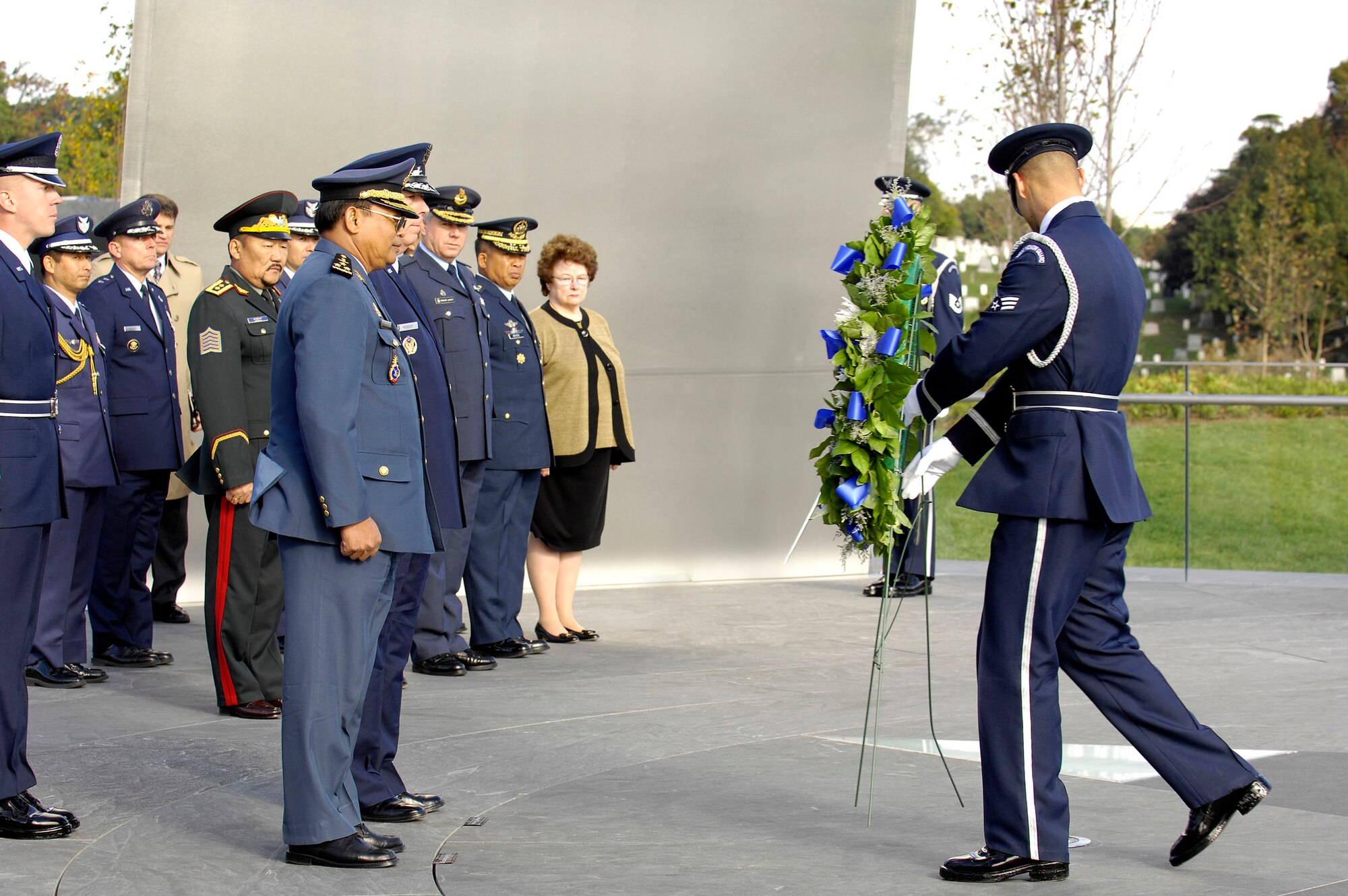 An Airman from the U.S. Air Force Honor Guard presents the wreath at the foreign dignitary arrival and wreath laying ceremony at the Air Force Memorial in Arlington, Va., on Oct. 24.  Air Force Chief of Staff Gen. T. Michael Moseley hosted the ceremony for nine Pacific air chiefs visiting Washington. Lt. Gen. Soeung Samnang, Cambodian Royal Air Force commander, represented the Pacific Air Chiefs  when he assisted Gen. Moseley during the ceremony. (U.S. Air Force photo/Senior Airman Desiree Andrejcik) 
