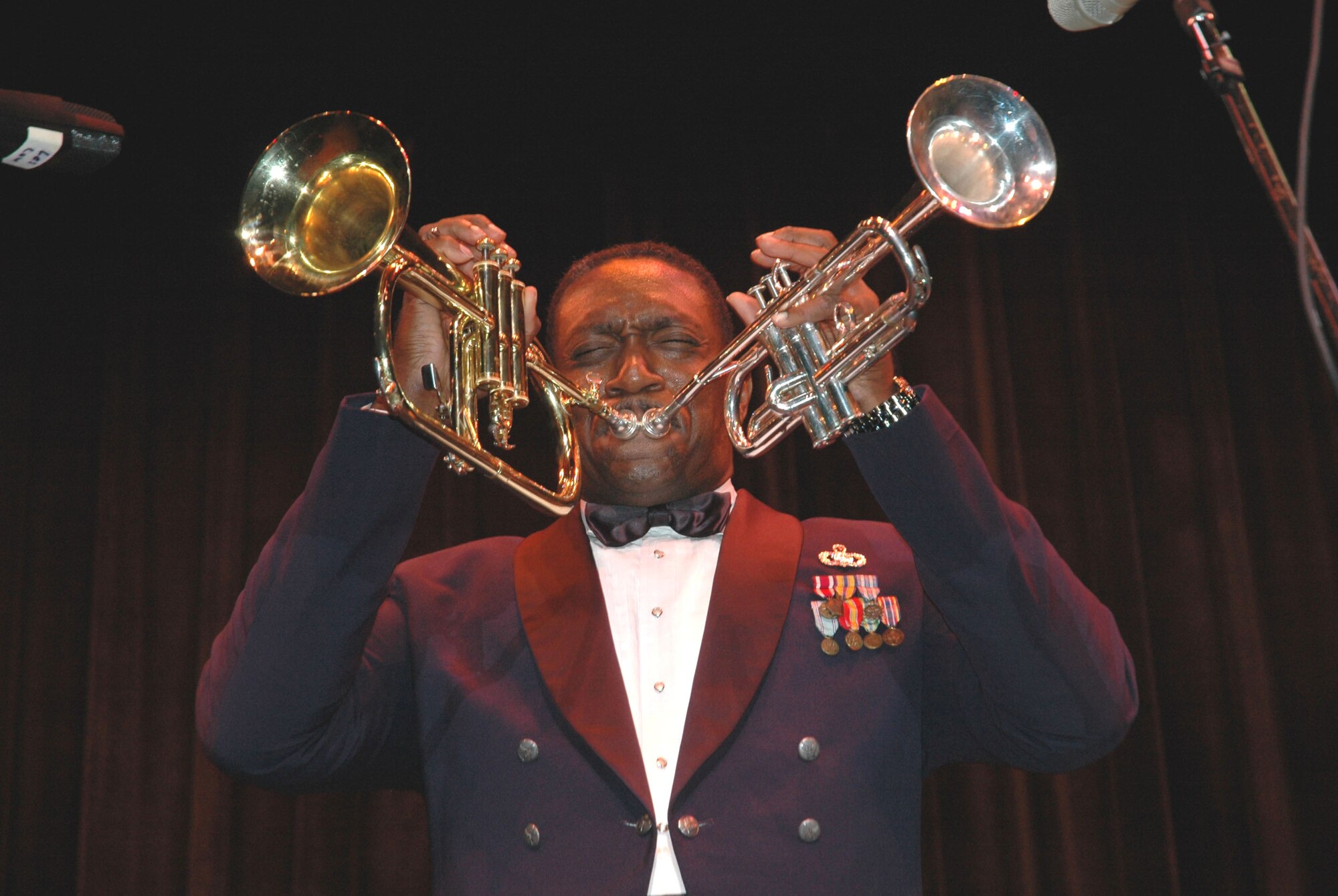 Master Sgt. Ken Trimmins performs at Delaware State University in Dover, Del., as part of the 512th Airlift Wing Band's "Strike Package." Sergeant Trimmins, NCO in charge of the Air Force Reserve Band's Full Spectrum, was featured on the Jay Leno Show in 2002 for his unique ability to play two trumpets simultaneously. Three Air Force Reserve bands played at various venues in Dover Oct. 19 to 21. Almost 7,000 people attended the performances and approximately 50,000 more tuned in to hear one of the bands perform live on a morning radio show. (U.S. Air Force photo/Tech. Sgt. Veronica Aceveda) 
