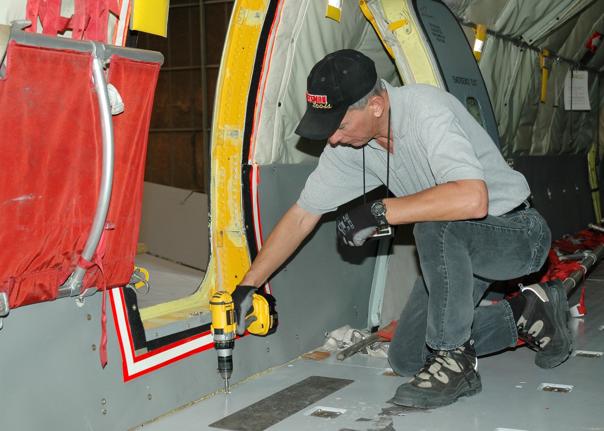 Air Force Reserve Technician, Tech. Sgt. Bill Pollard, 940th Maintenance Squadron crew chief, removes bolts from the floor of a KC-135T Stratotanker in preparation of a cable inspection Oct. 24, 2006 at Beale Air Force Base, Calif.  The aircraft phase inspection takes nearly a month to check the jet from head to toe for wear and tear, but maintains integrity of the aircraft and helps ensure safe flying. (U.S. Air Force photo/Stacey Knott)