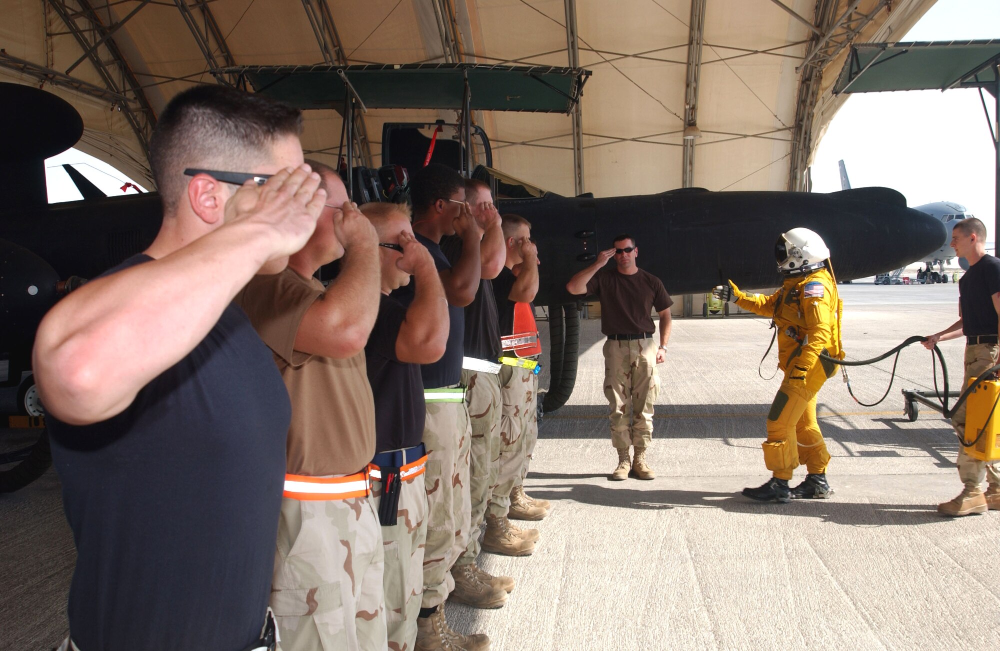 Airmen from the 380th Expeditionary Aircraft Maintenance Squadron salute Capt. Karl Frederick as he walks toward his U-2 Dragonlady Oct. 24. The salute is a preflight tradition before a launch. Captain Frederick and Airmen from the 380th EAMXS are part of the vital intelligence, surveillance and reconnaissance mission for Operations Enduring Freedom and Iraqi Freedom in Southwest Asia. (U.S. Air Force photo/Master Sgt. Jason Tudor)