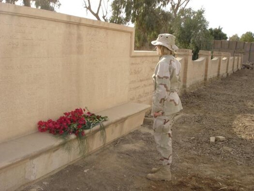 Capt. Jutta Cortes, 20th Air Force, stands in the cemetery at Camp Habbaniyah, Iraq, which she helped to restore recently.