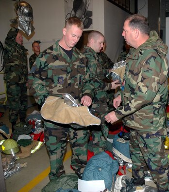 Staff Sgt. Justin Kevelin, 934th Airlift Wing firefighter, shows his equipment to an inspector as part of the Unit Compliance Inspection during the October UTA.  (Photo by Master Sgt. Paul Zadach)