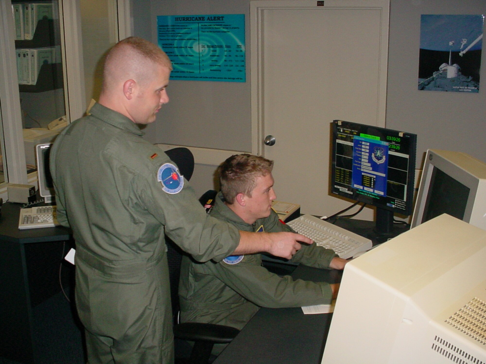2nd Lt. Keith Harrigan, Echo Crew commander, and Airman 1st Class Seth Chapman, space console operator, monitor a console in the Space Operations Center at Eglin AFB, Fla. The two are part of the 20th Space Control Squadron.
U.S. Air Force photo by Capt. Rudi DiAmco                             