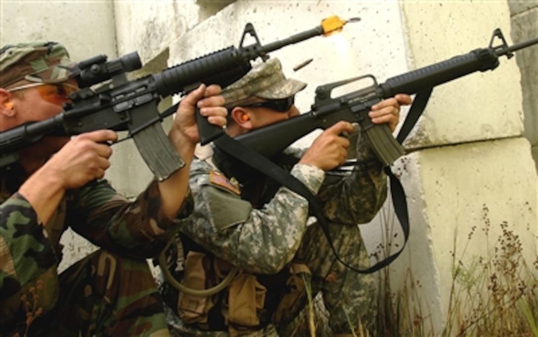 Senior Airmen Justin Priniski and Pvt. Brian Eatmon return fire against simulated insurgents duirng Atlantic Strike IV at Avon Park, Fla., Oct. 23, 2006. Atlantic Strike is a U.S. Central Command Air Force initiative dedicated to supporting the war on terrorism. It includes more than 700 joint participants in seven days of training operations.