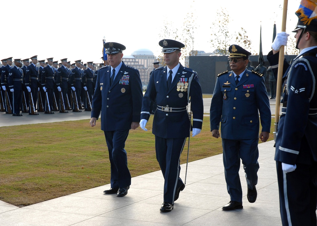 Chief of Staff of the Air Force Gen. T. Michael Moseley and Lt. Gen. Soeung Samnang, Cambodian Royal Air Force commander, are escorted by Lt. Col. Gaylord Thomas, Air Force Honor Guard commander, to inspect the troops during a foreign dignitary arrival and wreath laying ceremony Tuesday, Oct. 24, 2006, at the Air Force Memorial. (U.S. Air Force photo/Staff Sgt. Madelyn Waychoff)