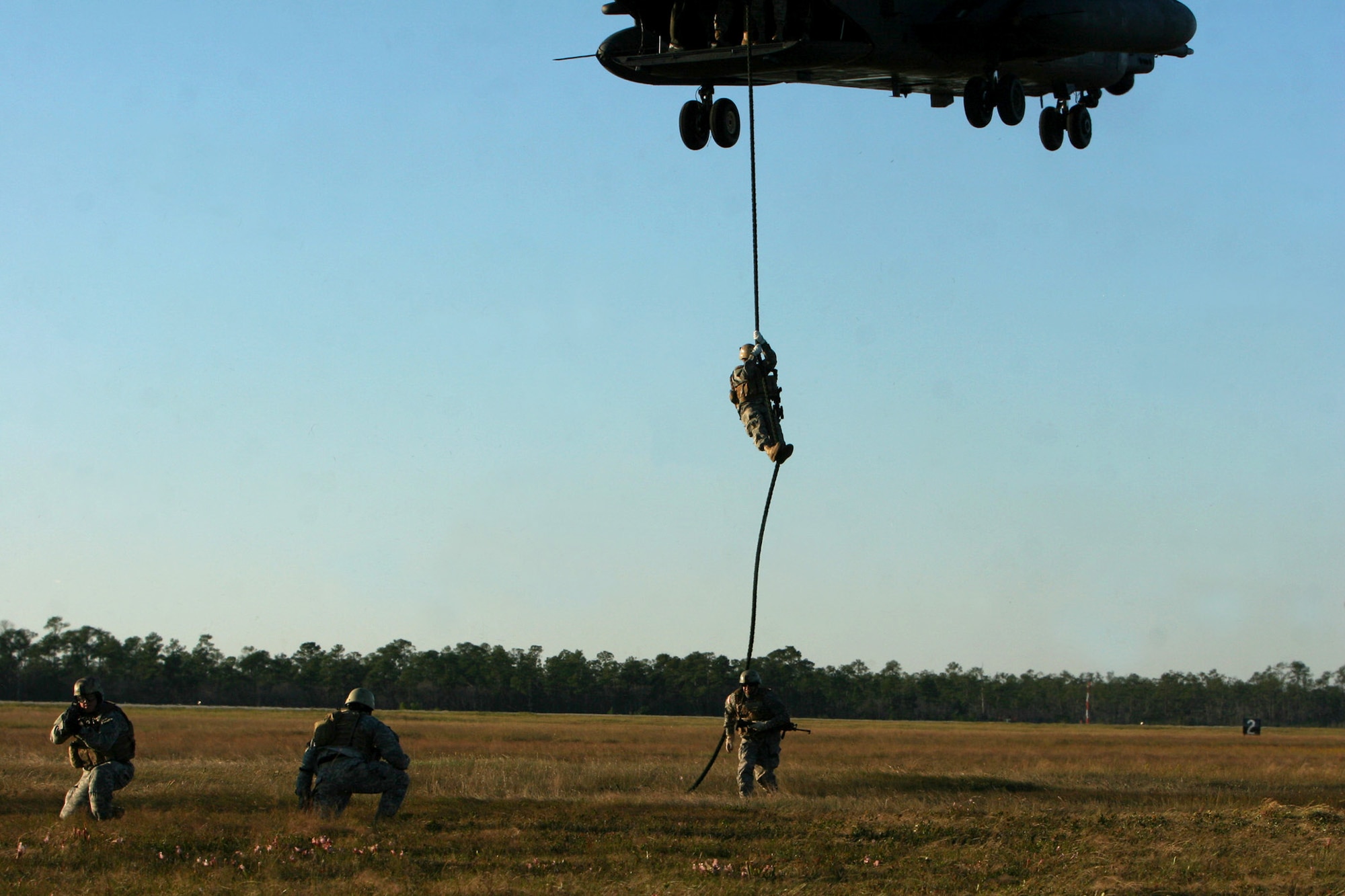 Green Berets practice "fast-roping" from the tail of a MH-53 helicopter Oct. 23 at Hurlburt Field, Fla, in preparation for Exercise Emerald Warrior '07. The Air Force Special Operations Command's first joint coalition exercise will focus on training Air Force, Army and allied units in missions directly related to the war on terrorism. The exercise will operate from Oct. 25 to Nov. 3. (U.S. Army photo/ Staff Sgt. Cain S. Claxton)