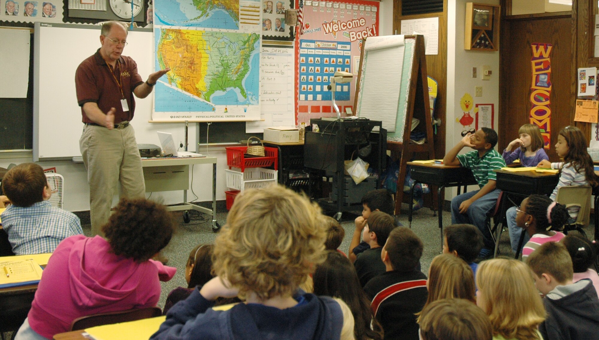 Minot Air Force Base, N.D. --- Tom Schrader a meteorologist with a local television station explains the how the difference between high and low pressure areas affect the formation of storms during a visit to the fourth grade class at Dakota Elementary school here.  Mr. Schrader visits on-base students annually to talk to them about meteorology and dispel some of the myths about what actions to take during inclement weather.  (U.S. Air Force photo by Capt James Bressendorff)