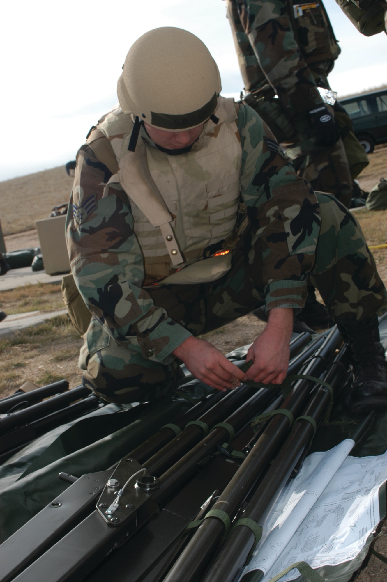 A Warren Airman unties a ribbon that holds the stakes to the tent he will be working from during the deployment exercise held here at Warren October 25, 2006.  The exercise tested the deployment capabilities of the base and 112 Warren members.