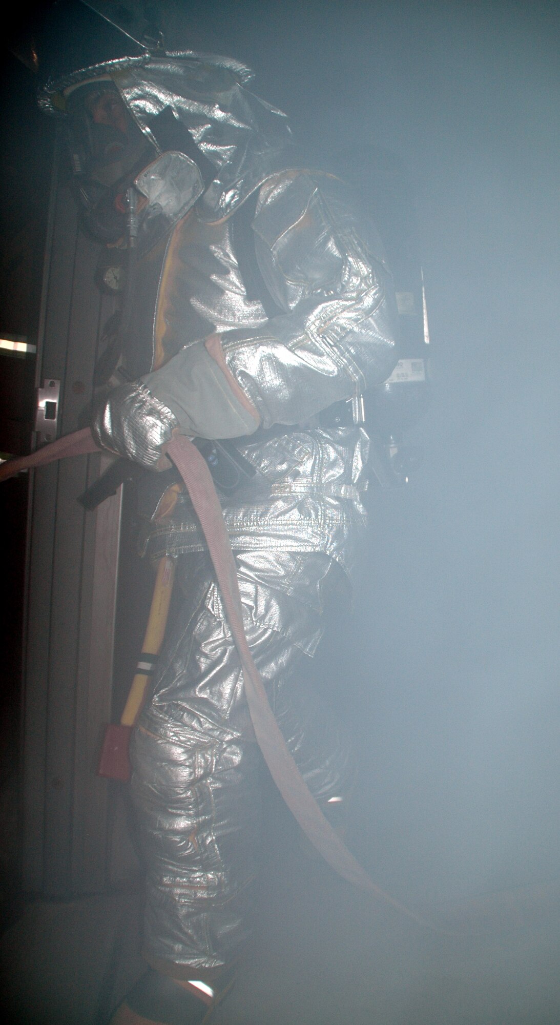 WRIGHT-PATTERSON AFB, Ohio -- Firefighter SrA Glen Beddies Jr., from the 445th Civil Engineer Squadron’s Fire Fighting Flight enters a dense smoked building to look for victims of smoke inhalations.  It’s estimated that 50-80 per cent of fire deaths are the result of smoke inhalation injuries rather than burns. (U.S. Air Force photo/Tech. Sgt. Charlie Miller).