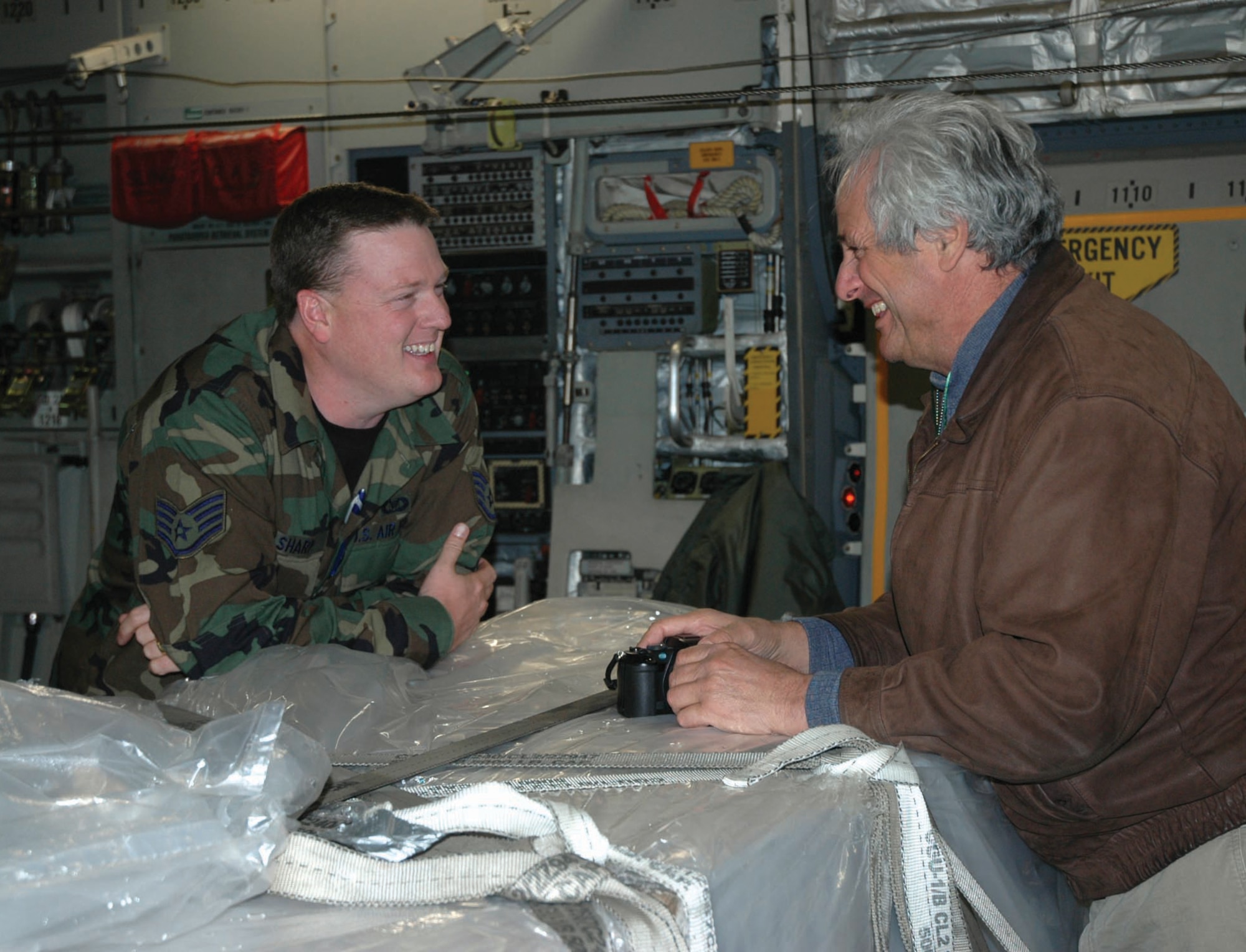 MCCHORD AIR FORCE BASE, Wash., - Staff Sgt. Bradley Sharp, 36th Aerial Port Squadron, talks with his civilian employer, Michael Walker aboard a C-17 during Employer Orientation Day Oct. 21. Culminating with an orientation flight, the semi-annual event  highlights the 446th Airlift Wing's mission to civilian employers of McChord Reservists.