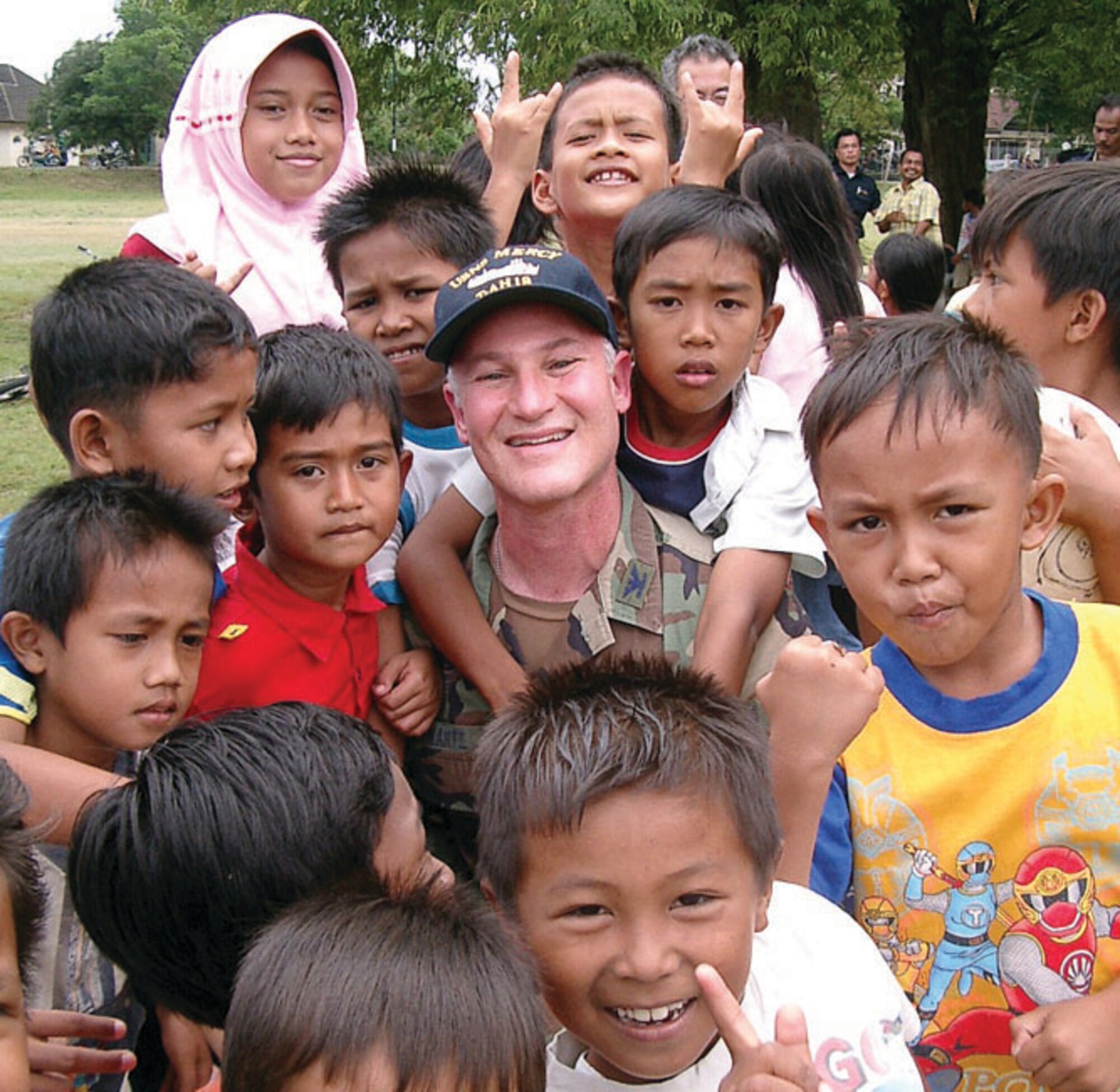Colonel Jeffrey Swartz, 56th Dental Squadron commander, poses with local children outside Kesdam Military Hospital in Banda Aceh, Indonesia, during his Aerospace Expeditionary Force deployment. Banda Aceh was ground zero for the December 2004 Tsunami.  (Courtesy Photo)