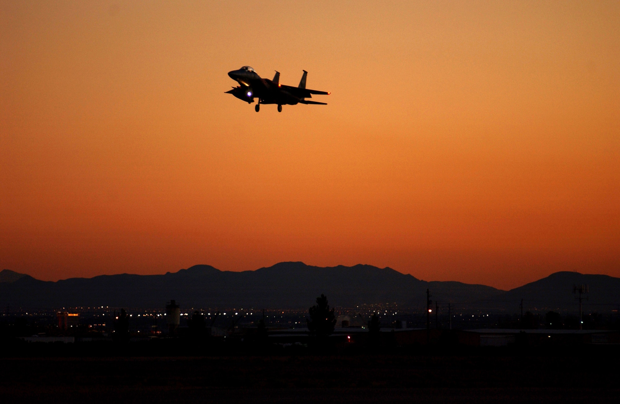 An F-15 participating in Exercise Red Flag 07-1 approaches Nellis Air Force Base, Nev., on Oct. 19, 2006.  Red Flag tests aircrews’ war-fighting skills in realistic combat situations. The aircraft fly missions during the day and night to the nearby Nevada Test and Training Range where they simulate an air war. U.S. service members, with representatives from each branch of service along with coalition forces, participate in Red Flag.  (U.S. Air Force photo/Airman First Class Brian Ybarbo)

