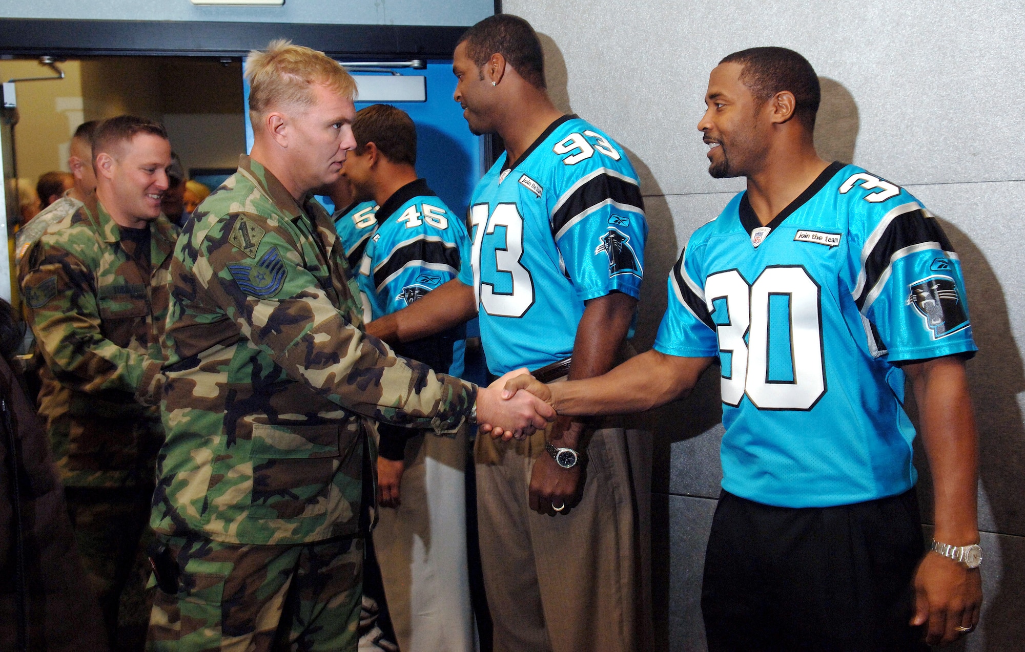Tech. Sgt. Greg Overbay meets Carolina Panthers safety Mike Minter as part of Operation Welcome Home, inside the Bank of America Stadium, Charlotte N.C., on Oct. 24. OWH allowed military members from the Air Force, Army, Navy and Marines to tour the stadium and meet several players from the Carolina Panthers as a thank you after deploying in support of Operations Iraqi Freedom and Enduring Freedom. Sergeant Overbay is in the Air National Guard and is a tactical air controller with the 118th Air Support Operations Squadron, New London, N.C. (U.S. Air Force photo/Tech. Sgt. Larry A. Simmons)