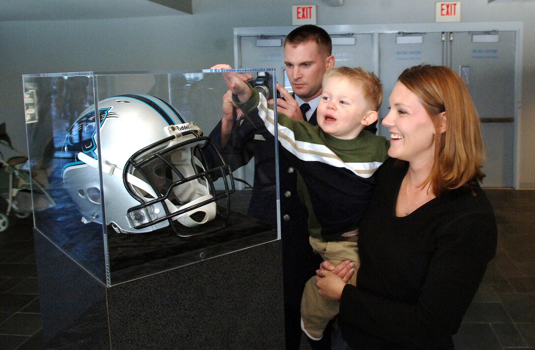 Staff Sgt. Steven Stone, wife Melissa and son Gavin, 2, view an incased Carolina Panthers helmet while at the Bank of America Stadium, Charlotte N.C., as part of Operation Welcome Home, on Oct. 24. OWH allowed military members from the Air Force, Army, Navy and Marines to tour the stadium and meet several players from the Carolina Panthers as a thank you for deploying in support of Operations Iraqi Freedom and Enduring Freedom. Sergeant Stone is with the 437th Civil Engineering Squadron, Charleston Air Force Base, S.C. (U.S. Air Force photo/Tech. Sgt. Larry A. Simmons)