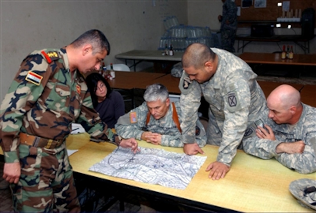U.S. Army Gen. George William Casey Jr. (center), commanding general, Multi-National Forces – Iraqi, and Col. Ali (left), commander, 4th Battalion, 6th Brigade, 6th Iraqi Army Division, discuss plans of action for Yusufiyah, Iraq, Oct. 22, 2006. 


