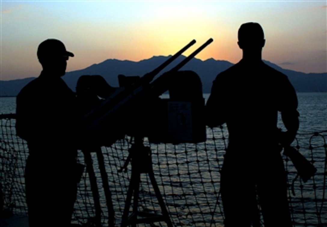 U.S. Petty Officer 2nd Class Paul Larson (left) and Petty Officer 2nd Class Shawn Carrier stand Force Protection watch on the guided missile destroyer USS Stethem while moored in Subic Bay, Oct. 20, 2006.