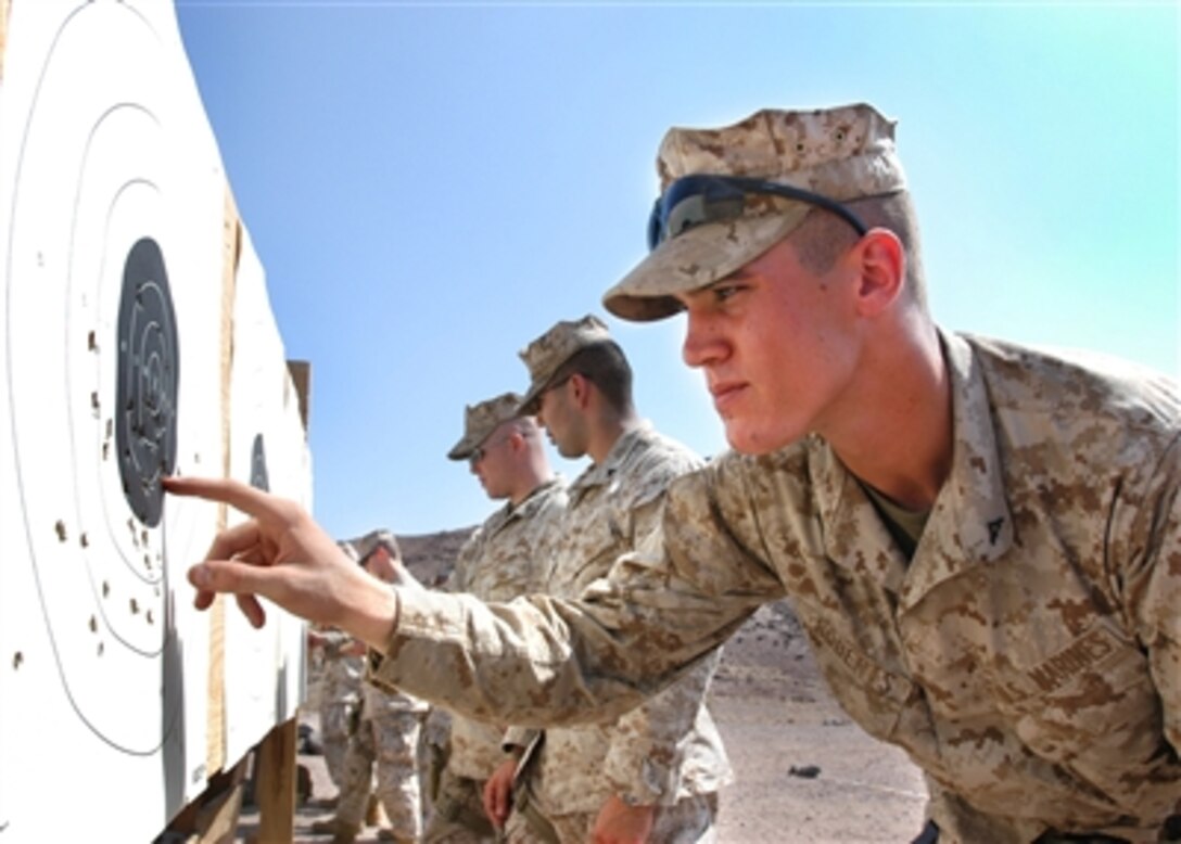 Marine Lance Cpl. Derek Roberts adds his score during a 9 mm pistol qualification for 5th Provisional Security Company Marines in Arta, Djibouti, on Oct. 3, 2006.  The Marines of the 5th are the security force for Camp Lemonier in Djibouti, home of the Combined Joint Task Force - Horn of Africa.  