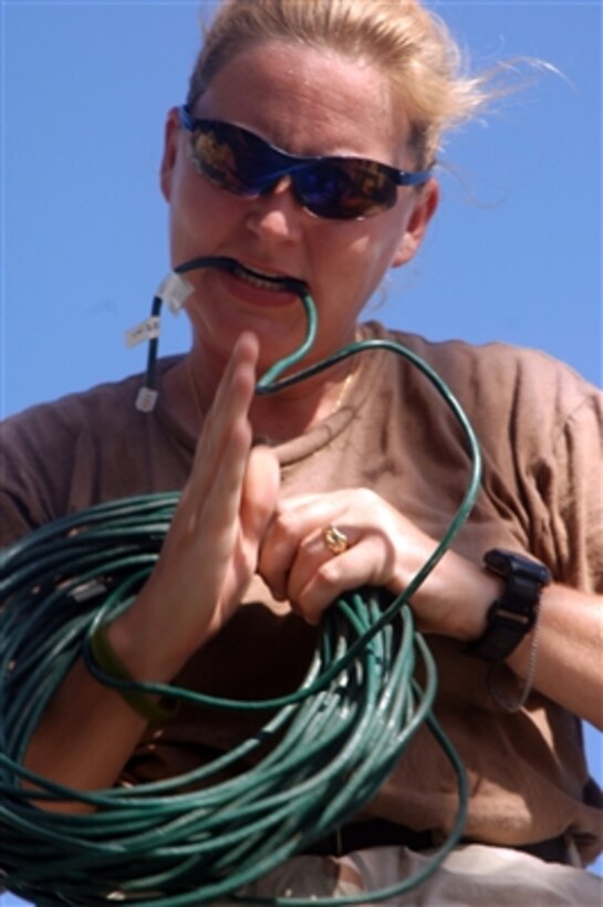 Petty Officer 1st Class Sharon Walter prepares to install modified network cables into the Navy's new Joint Maritime Afloat Staging Terminal in the Persian Gulf on Oct. 19, 2006.  The center will provide commanders with enhanced command, control, and communications with forces conducting maritime security operations in the Persian Gulf.  