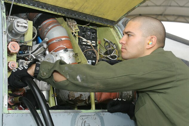 Cpl. Thomas P. Olsen (left) and Lance Cpl. Joshua S. Ybarra take a break while working on an AH-1W Super Cobra at Al Taqaddum, Iraq, Oct. 25. Both Marines are UN/AH-1 helicopter airframe mechanics with Marine Light Attack Helicopter Squadron 367, Marine Aircraft Group 16 (Reinforced), 3rd Marine Aircraft Wing (Forward), which assumed responsibility for providing close air support and casualty evacuation escort missions from HMLA-169, MAG-16, 3rd MAW. Olsen is a San Diego native. Ybarra is an Austin, Texas, native.