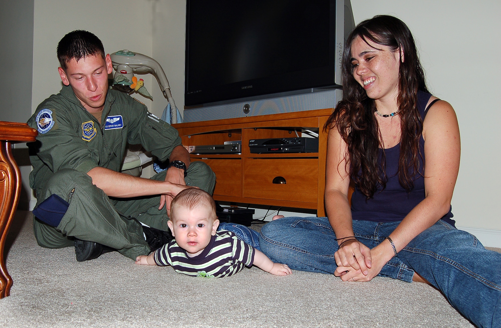 Airman 1st Class Derrick Maloney and his wife Jeema play with their 6-month-old son, Tyler, at their home in North Charleston, S.C., prior to his C-17 Globemaster III training mission Oct. 26. Airman Maloney is a loadmaster with the 17th Airlift Squadron. (U.S. Air Force photo/Tech. Sgt. Ben Gonzales)