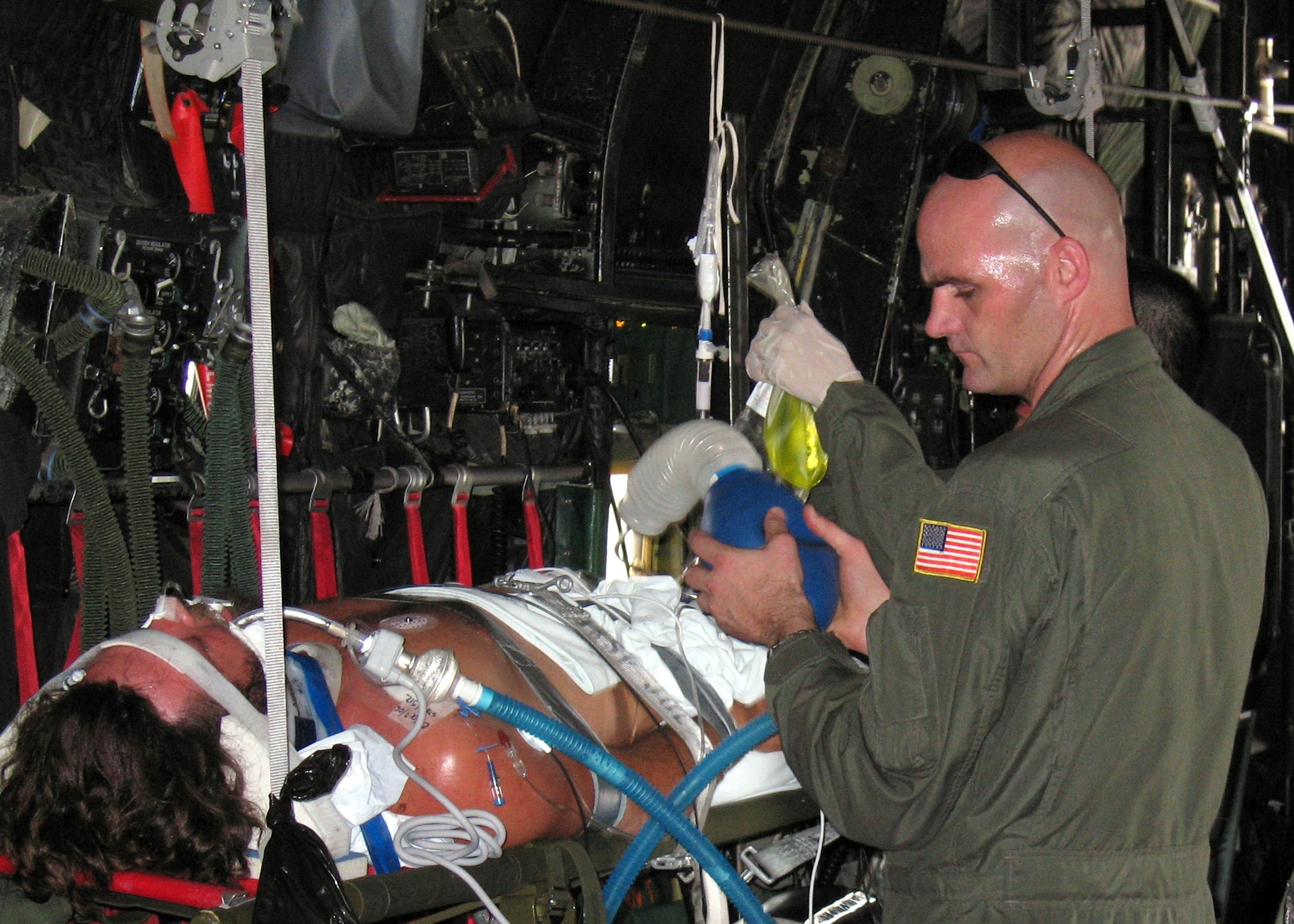 Master Sgt. Eric Degner provides manual air to the patient. (U.S. Air Force photo/Tech. Sgt. Elliott Paige) 