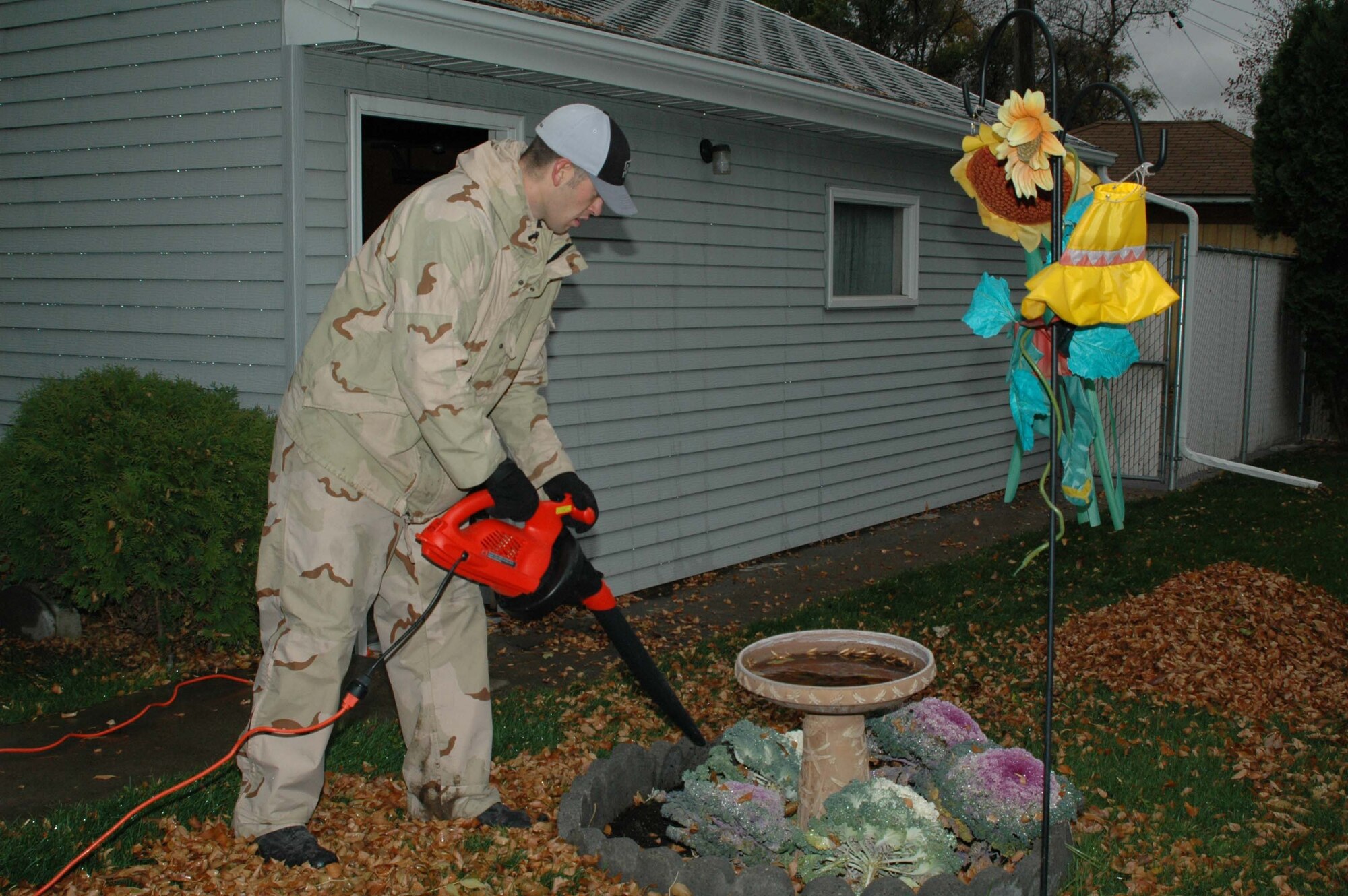 Senior Airman Jeff Ratliff, 819th RED HORSE Squadron, blows leaves into a pile to be picked up and disposed of during the Day of Caring Oct. 20. Nearly 120 volunteers from Malmstrom participated in the annual event helping community seniors get ready for the winter and doing household chores for them.