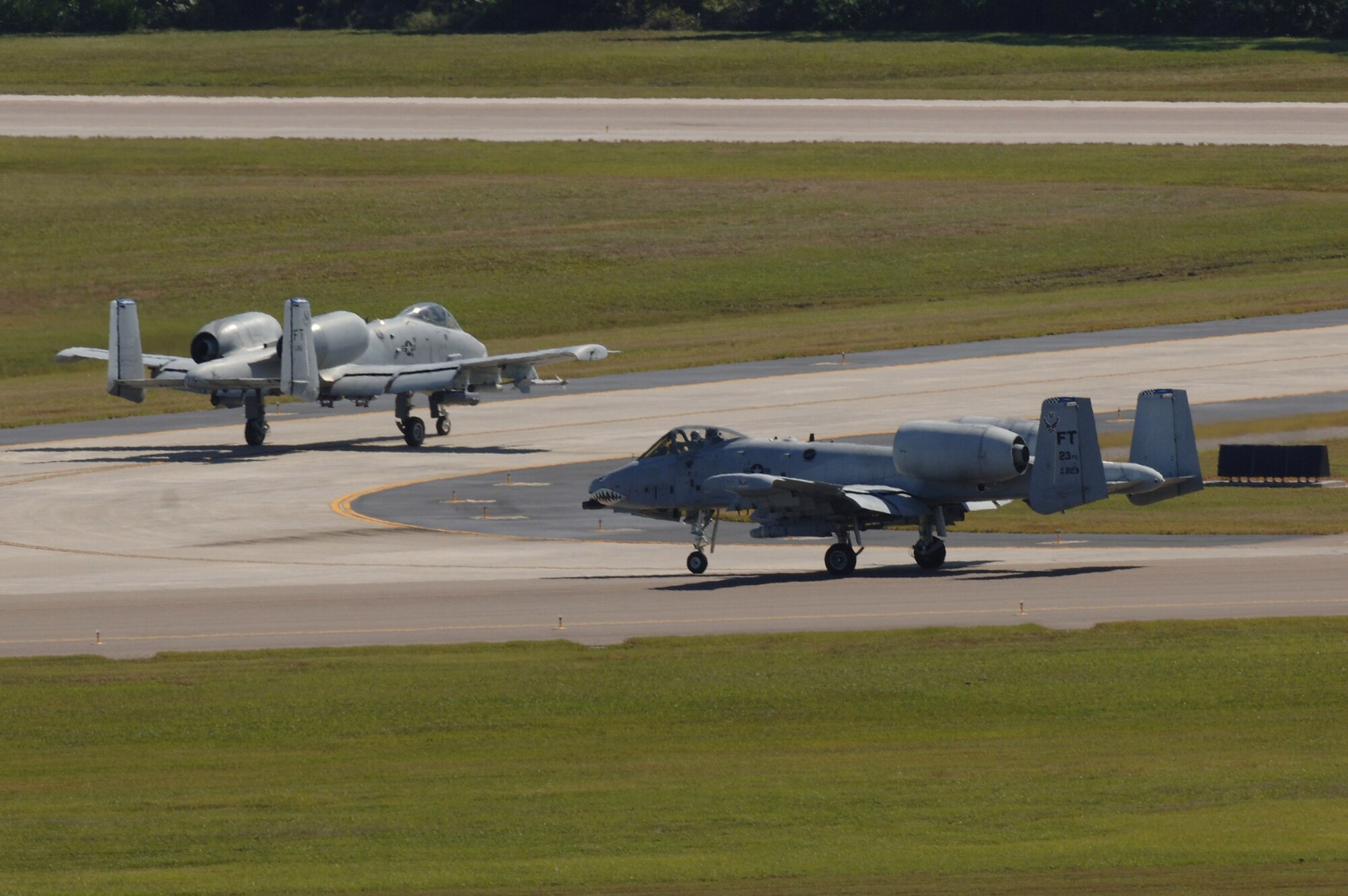 Two A-10 Thunderbolt IIs return to the aircraft parking area at MacDill Air Force Base, Fla., after flying an Atlantic Strike exercise mission Oct. 24.  The fighters, from the 23rd Fighter Group at Pope AFB, N.C., were at MacDill for the U.S. Central Command bi-annual Atlantic Strike training event.  Through realistic close-air support training, Atlantic Strike is designed to better prepare aircrews and Air Force joint tactical air controllers for deployments.  (U.S. Air Force photo/Senior Airman Jason Robertson)