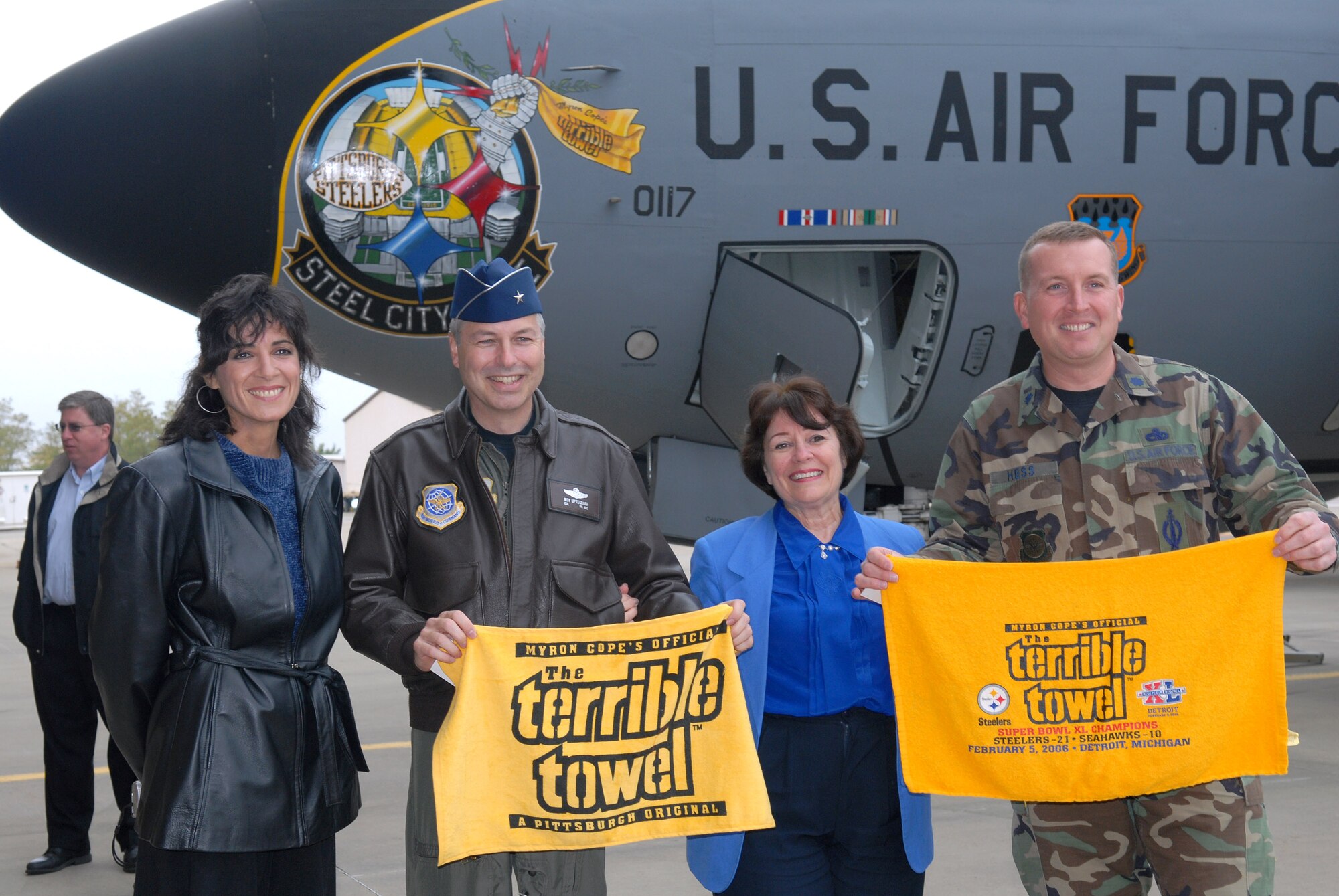 Artist Donna Pitaro joins Brig. Gen. Roy Uptegraff, attorney Ruth Zittrain and Lt. Col. Tom Hess Oct. 18 along with the Airmen of the Pennsylvania Air National Guard's 171st Air Refueling Wing in celebrating the unveiling of the new "Steel City Pride" nose art that appears on the unit's KC-135 Stratotankers.  Ms. Pitaro designed the nose art.  General Uptegraff is the 177th ARW commander and Colonel Hess is the wing's aircraft maintenance officer.  (U.S. Air Force photo/Master Sgt. Ann Young)
