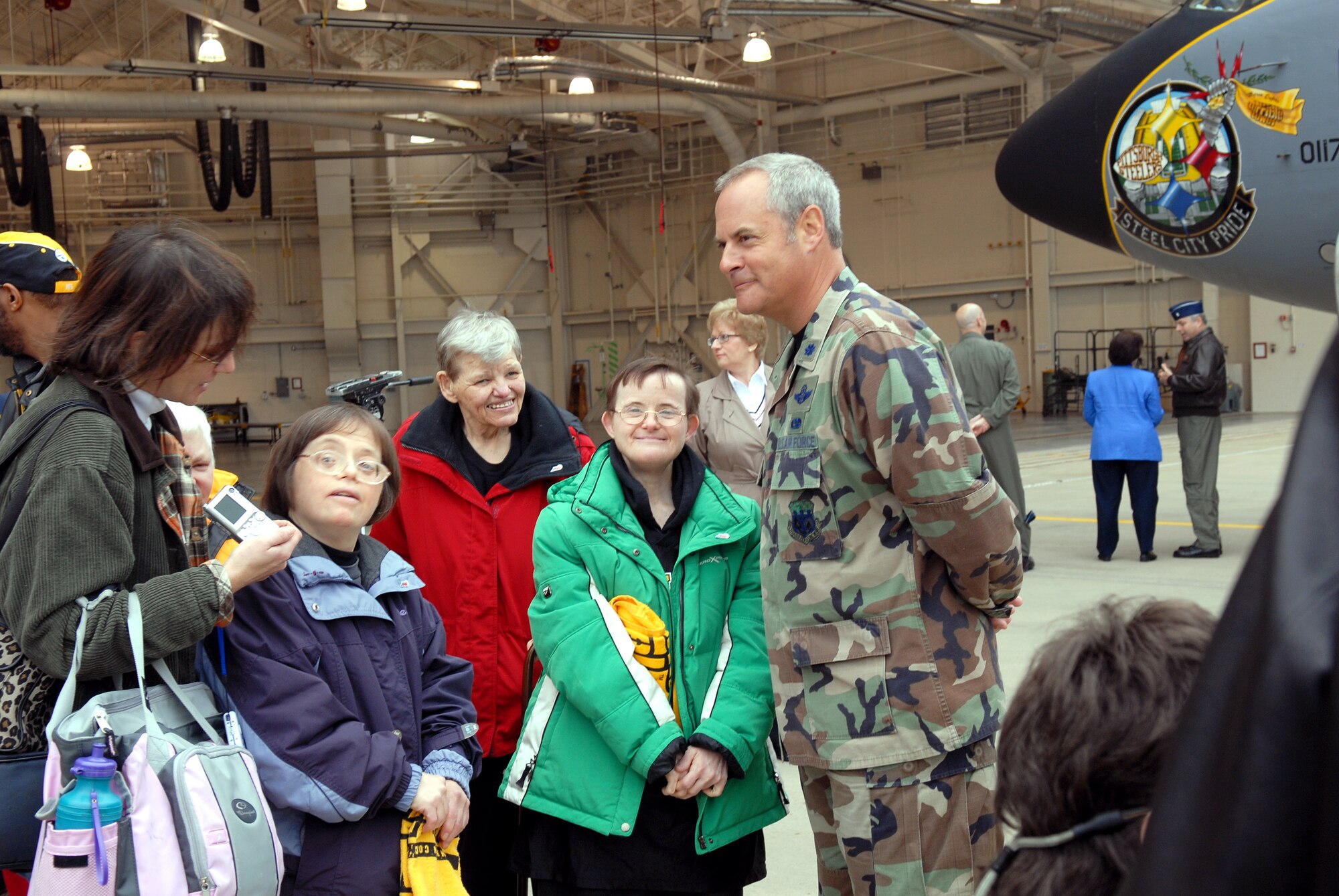 Lt. Col. Don Accamando chats with some of the residents of the Allegheny Valley School and members of the Pittsburgh Steelers football organization Oct. 18 who were on hand to help the Airmen of the Pennsylvania Air National Guard's 171st Air Refueling Wing christen the new "Steel City Pride" nose art on the unit's KC-135 Stratotankers.  (U.S. Air Force photo/Master Sgt. Ann Young)