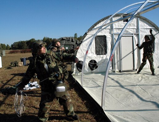 Staff Sgt. Chad Young, 5th Civil Engineer Squadron utilities craftsman, helps erect an Alaskan tent during the Eagle Flag exercise held at Lakehurst Naval Air Station, N.J., from Oct. 12 to 20. Airmen erected more than 40 tents during the exercise. (U.S. Air Force photo by Senior Airman Danny Moanahan)