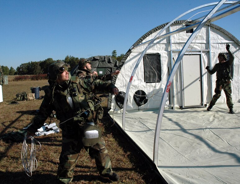 Staff Sgt. Chad Young, 5th Civil Engineer Squadron utilities craftsman, helps erect an Alaskan tent during the Eagle Flag exercise held at Lakehurst Naval Air Station, N.J., from Oct. 12 to 20. Airmen erected more than 40 tents during the exercise. (U.S. Air Force photo by Senior Airman Danny Moanahan)
