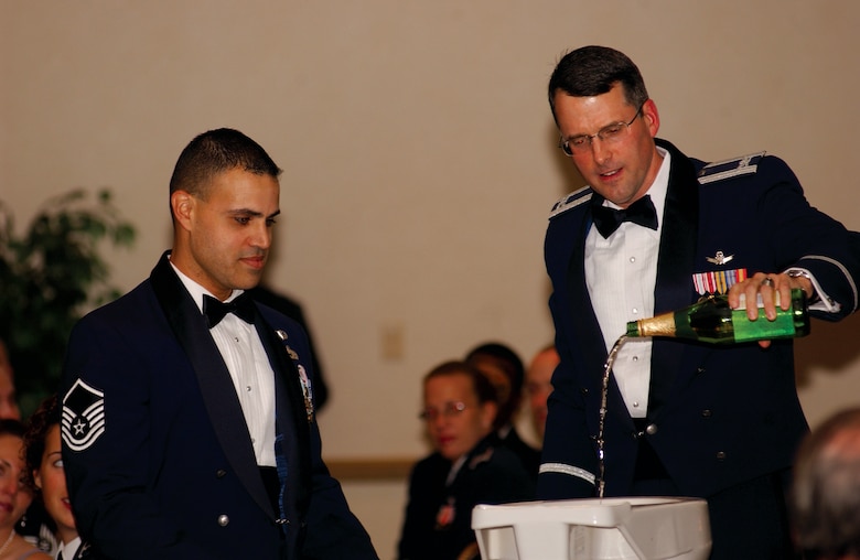 Col. Benjamin Huff, 30th Mission Support Group commander, and Master Sgt. David Matos, 30th Logistics Readiness Squadron, add apple cider to the grog bowl at the 30th Space Wing Dining Out here Oct. 20. 