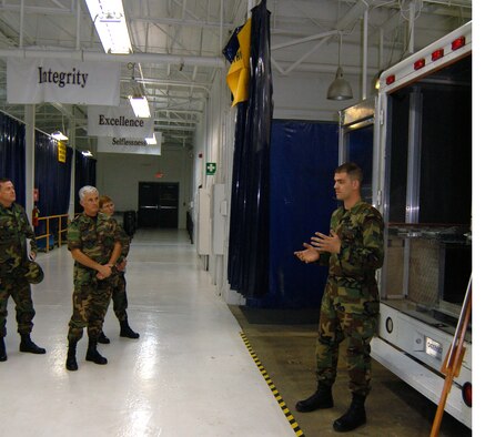 Airman 1st Class William Werner (right), 436th Maintenance Squadron aircraft metals technologist, briefs Col. William Wootton, Air Mobility Command Maintenance Division chief and Daedalian Award Team chief, and the rest of his team at the “Monster Garage” in Building 721 here Monday about various modifications to vehicles at Dover to increase load capacity and improve loading systems. Dover is one of three AMC bases in the running for the Maj. Gen. Clements McMullen Memorial Weapons System Maintenance Trophy. The award is presented annually to a U.S. Air Force unit at the wing level for having the best weapon system maintenance record for the preceding calendar year. This is the first time Dover AFB has been a finalist for the award since 1986.  The AMC Daedalian Award Team arrived here Sunday for a two-day tour of various facilities to observe the integration of maintenance with the total wing mission. The team’s itinerary included the “Monster Garage,” Isochronal Inspection Dock, Air Force Smart Operations 21 classroom, Combined Avionics System Trainer, and all other maintenance related facilities. (U.S. Air Force photo/Staff Sgt. James Wilkinson)