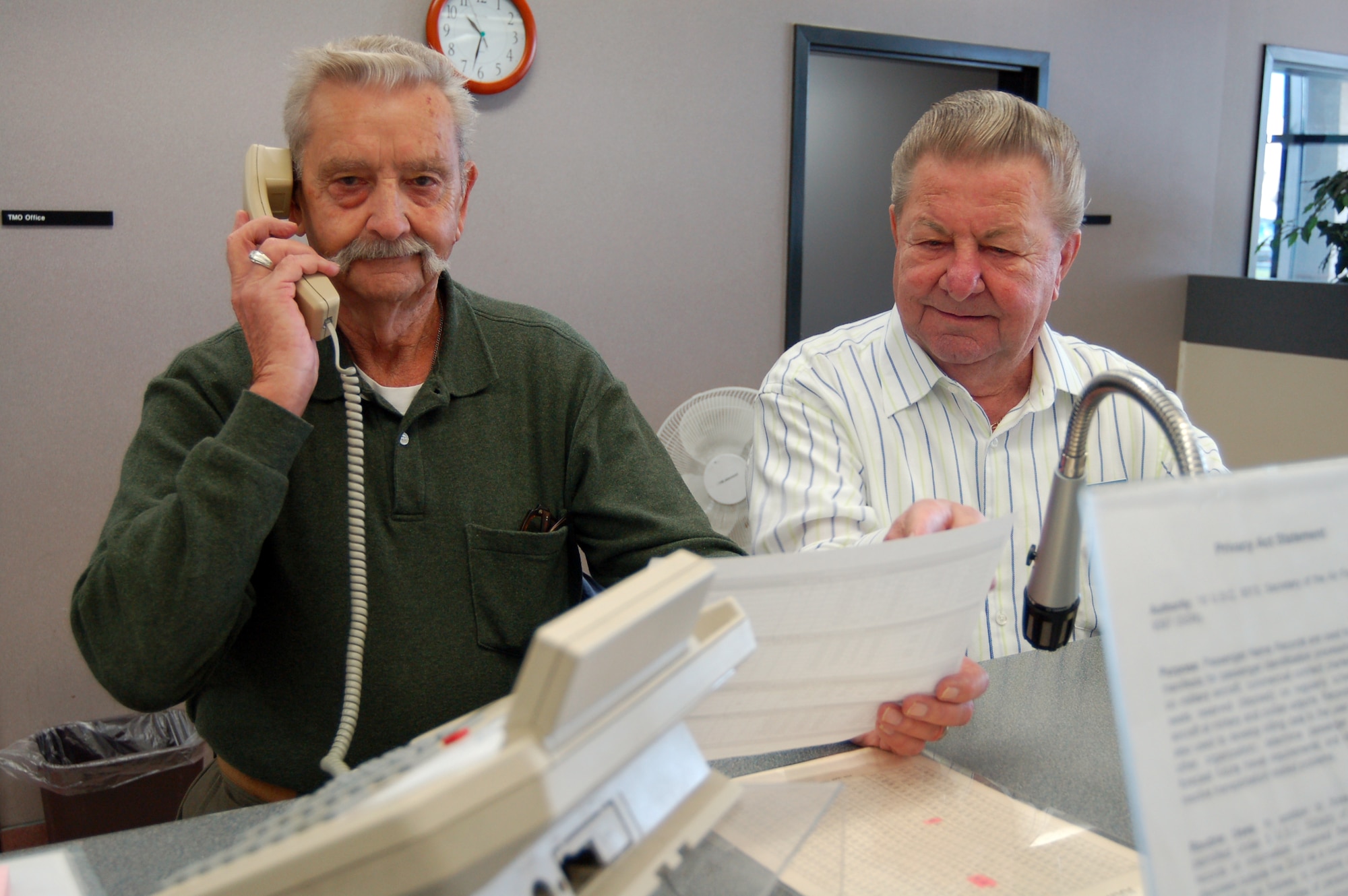Richard Muckey (left) and Joe Ostruska, volunteers and retired Air Force sergeants, help people make travel arrangements at the Air Terminal’s Passenger Service Center. Mr. Muckey has been a volunteer at the PSC for more than 15 years, and Mr. Ostruska has been a volunteer for 11 years. (U.S. Air Force photo/Staff Sgt. James Wilkinson)