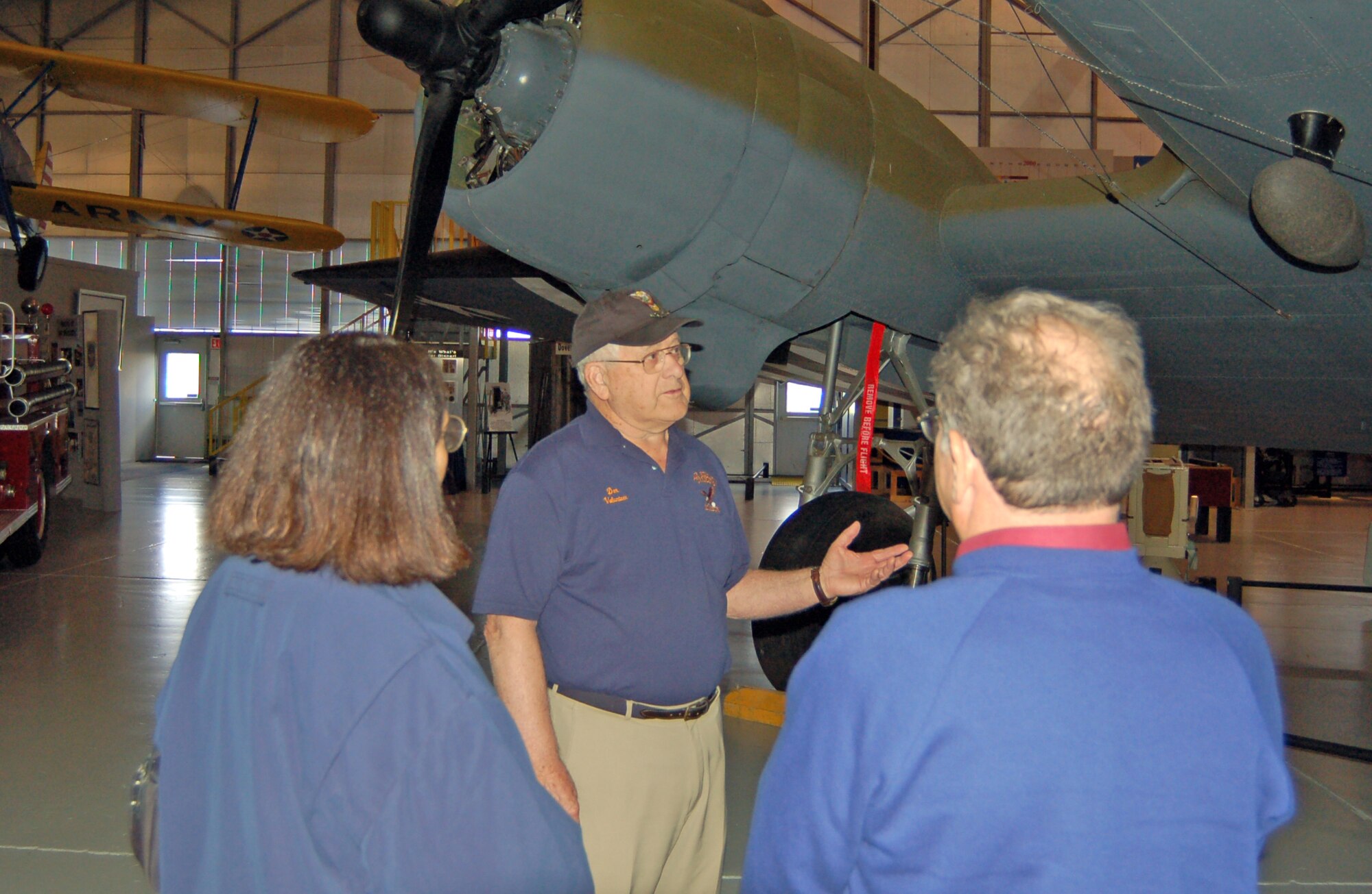 Don Clark (center), Air Mobility Command Museum volunteer and retired World War II C-47A pilot, tells Ellen Tress and Sid Edelman, visitors of the museum from Rockland County, N.Y., about the C-17A aircraft in the museum’s main exhibit Wednesday. Mr. Clark has given tours to museumgoers and history buffs at the museum for more than a year. (U.S. Air Force photo/Staff Sgt. James Wilkinson)