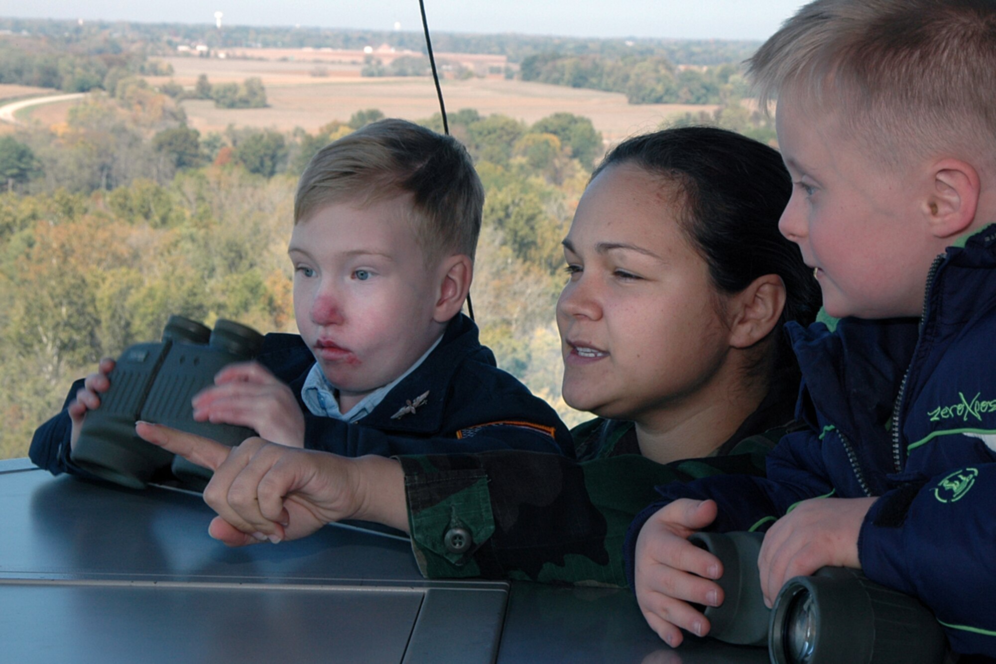 Air traffic controller Senior Airman Shaunna Barnett, 375th Operations Support Squadron, gives a tour of the Scott control tower to "Pilot for a Day" Josh Staley (left) and his best friend Jake. (U.S. Air Force photo by Marv Lynchard.)