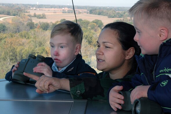 Air traffic controller Senior Airman Shaunna Barnett, 375th Operations Support Squadron, gives a tour of the Scott control tower to "Pilot for a Day" Josh Staley (left) and his best friend Jake. (U.S. Air Force photo by Marv Lynchard.)