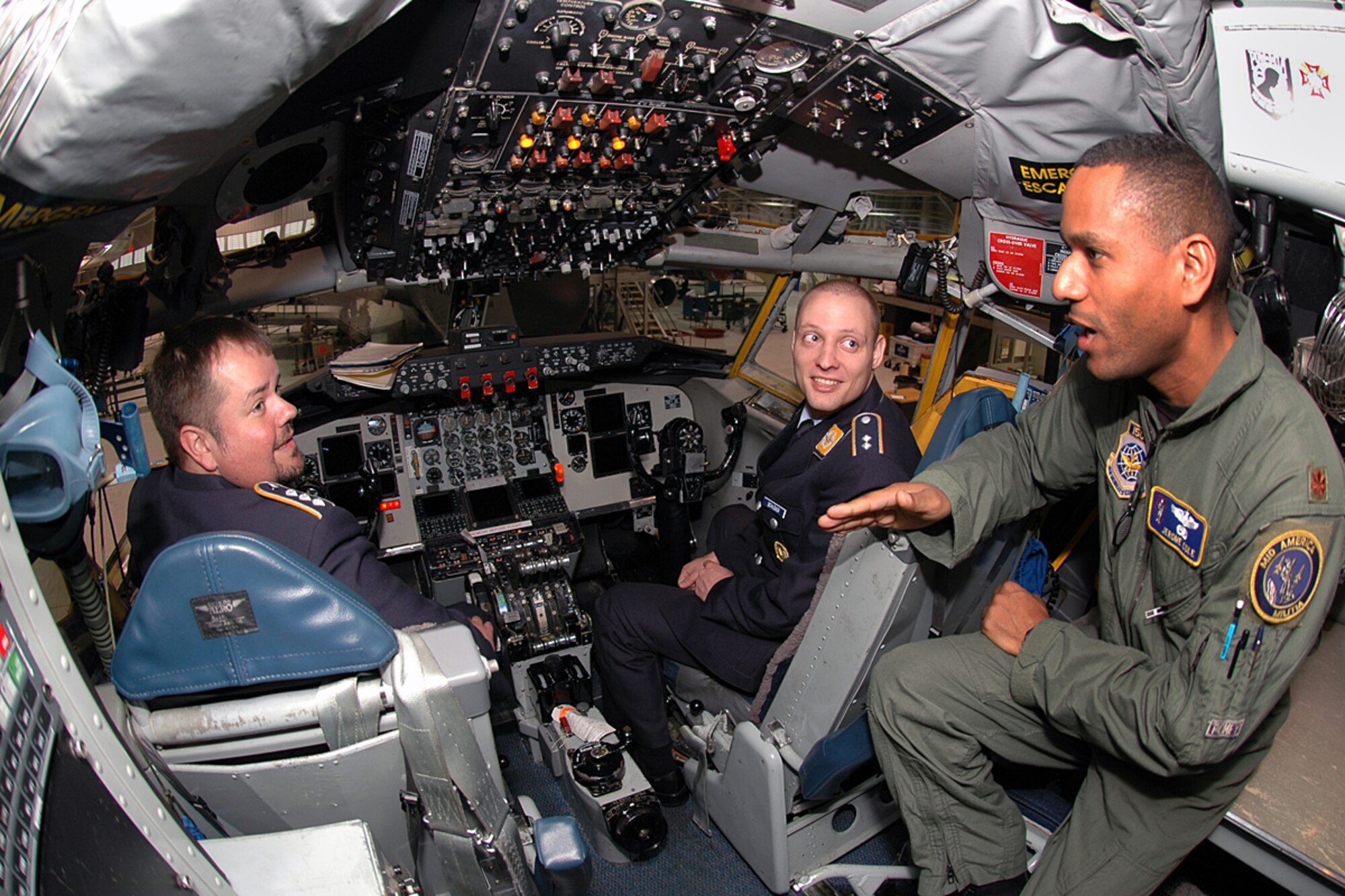 Maj. Jerome Cole, 126th Air Refueling Wing, gives a flight deck tour of the KC-135 Stratotanker to Capt. Winkler (left) and 1st Lt. Schlosser of the German air force. (U.S. Air Force photo by Marv Lynchard.)