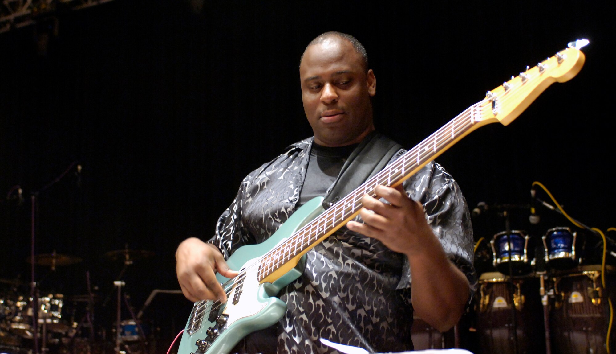 Staff Sgt. Terry Grace, bassist with Reserve Generation, plays for third through seventh grade students attending an anti-drug concert Oct. 25 at Trinity University in San Antonio.  The concert was part of National Red Ribbon Week, an anti-drug campaign focused on educating individuals, families and communities on the destructive effects of drugs and the positive alternative life choices that are available to youth.  The 2006 Red Ribbon Week runs from Oct. 23 to 29. Reserve Generation is part of the Air Force Reserve Command Band at Robins Air Force Base, Ga. (U.S. Air Force photo/Senior Airman Brian Ferguson)