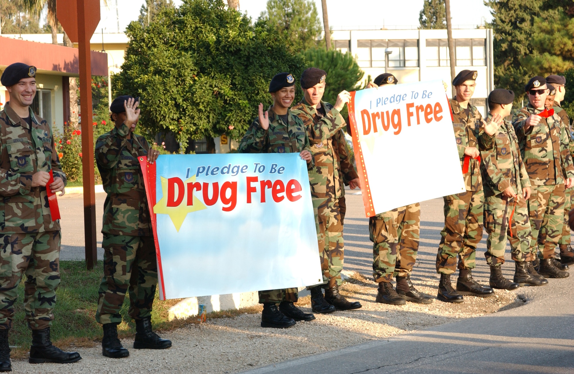 Security Forces members wave to students marching in the Red Ribbon Week parade Oct. 26. The parade started at Incirlik American School and ended at the commissary where the students were given their red ribbons. (U.S. Air Force photo by Airman 1st Class Tiffany Coulburn)        