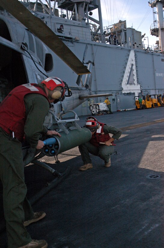 ABOARD USS BOXER, At Sea (Oct. 27, 2006) - Aviation Ordnance Marines assigned to Marine Medium Helicopter Squadron 165 (Reinforced), 15th Marine Expeditionary Unit (Special Operations Capable) aboard USS Boxer (LHD 4) load 2.75-inch rockets onto a AH-1W Super Cobra helicopter during Malabar 2006.  Malabar 2006 is a multinational exercise between the U.S., Indian and Canadian armed forces to increase interoperability between the three nations and support international security cooperation missions.