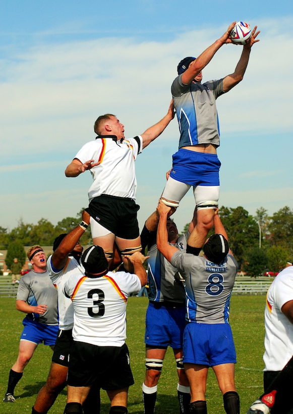 MARINE CORPS BASE CAMP LEJEUNE, N.C. - Jason Gurtz (left), Marine Corps, and Adam Casies, Air Force, are hoisted into the air during a line out during their game against each other in the first day of play for the Armed Forces Rugby Tournament here Oct. 25. (Official U.S. Marine Corps photo by Cpl. Brandon R. Holgersen)(released)