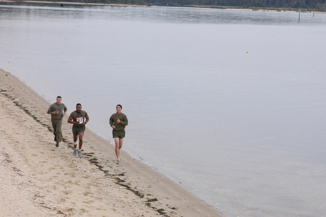 VERIN: 061024-M-1273D-001::n::MARINE CORPS AIR STATION CHERRY POINT, N.C. (Oct. 27, 2006) – A team from the Provost Marshal Office completes the beach run during the All Terrain Race here.  The race spanned seven and a half miles and included five all-terrain stations. (Official Marine Corps photo by Cpl. Lydia Davey)(released)::n::
