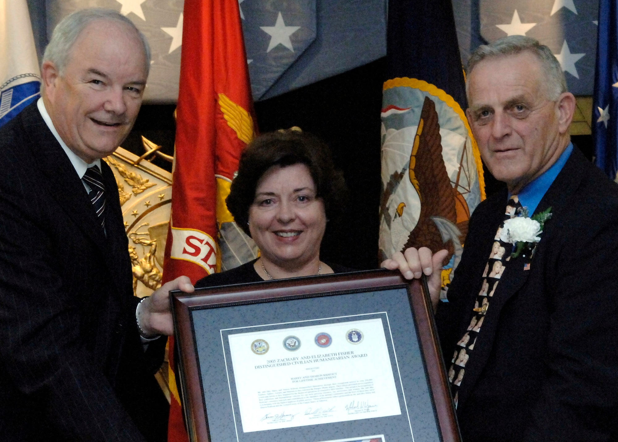 Secretary of the Air Force Michael W. Wynne presents Sharon and Harry Rideout with the 2006 Zachary and Elizabeth Fisher Distinguished Civilian Humanitarian Award Oct. 26 at the Pentagon.  Among their many accomplishments to support servicemembers, the Rideouts created the Bangor Greeters Group at Bangor International Airport, Maine.  The all-volunteer group greets Soldiers, Sailors, Airmen and Marines as they pass through the airport, either going to or returning from overseas deployments. (U.S. Air Force photo/Ron C. Hall)