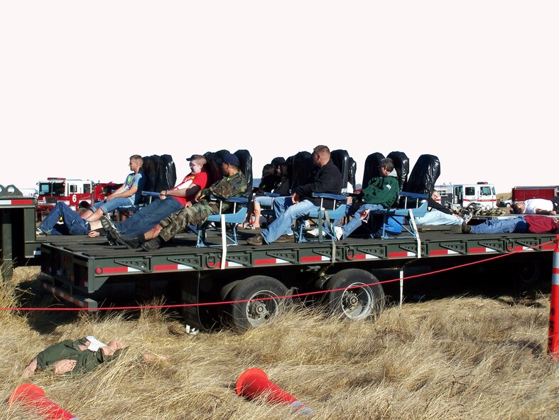 C-5 Galaxy crash "victims" await extraction from the simulated passenger cabin during Exercise "Aircraft Down," Oct. 19. More than 350 people took part in the largest exercise with the local community since 1998. Exercise “Aircraft Down” simulated the crash of a C-5 Galaxy in order to determine how the base and local community would respond.