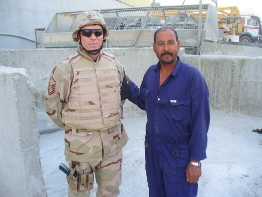 Master Sgt. Rich Mullee, 90th Maintenance Group Quality Assurance Section, (left) is currently deployed to Ali Al Salem Air Base, Kuwait.  He serves along with 135 other Airmen encompassing 61 different AFSCs in the force protection section of the 386th Expeditionary Security Forces Squadron Force Protection Flight. Posing with Sergeant Mullee is a local national concrete contractor, which is located outside the AAS perimeter.